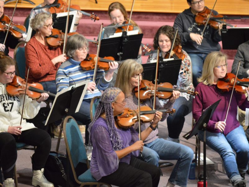 A group of violinists performing.