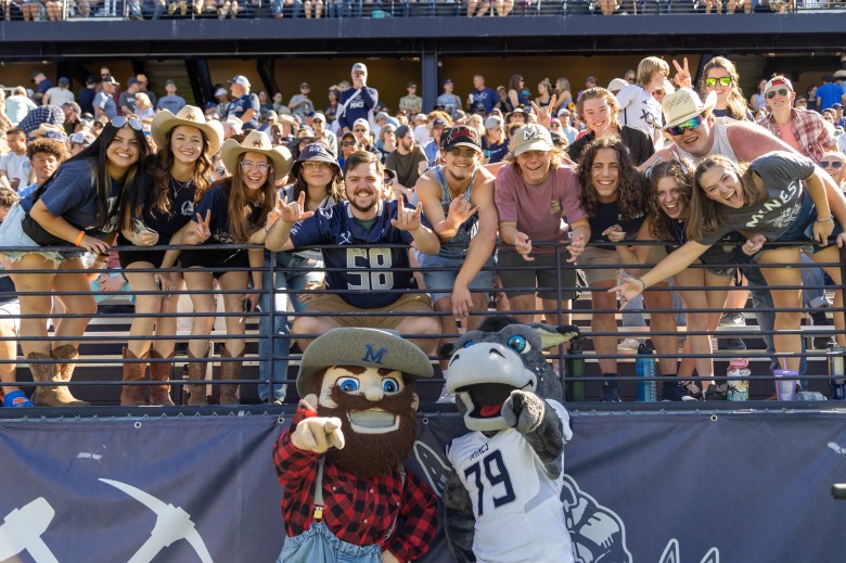 In front, mascots Marv the Miner and Blaster the Burro celebrate the Sept. 28 Homecoming football game with Colorado School of Mines fans