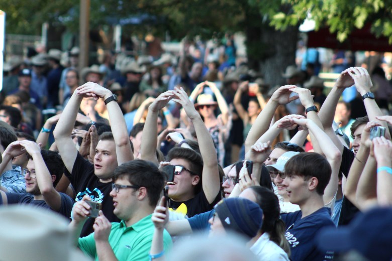 Colorado School of Mines students and alumni sing the school fight song during the Sept. 27 Sesquicentennial Bell unveiling ceremony in front of Guggenheim Hall