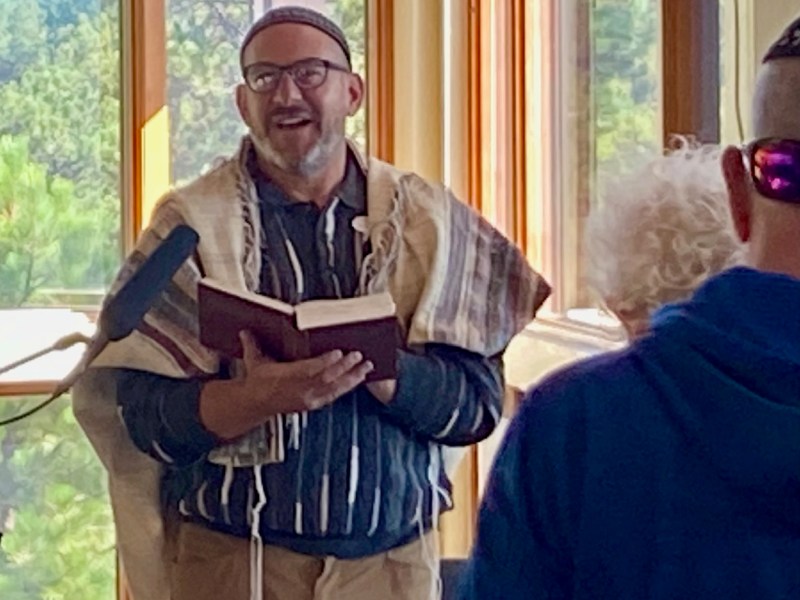Rabbi in sweater leading congregation