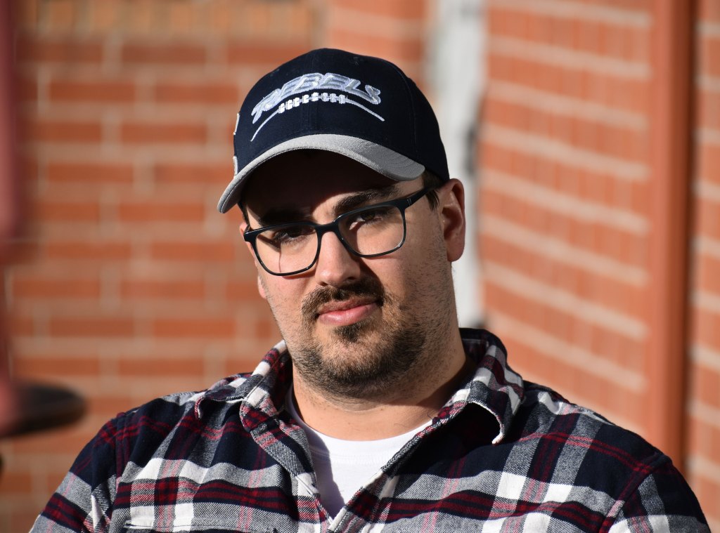 A man wearing a maseball hat