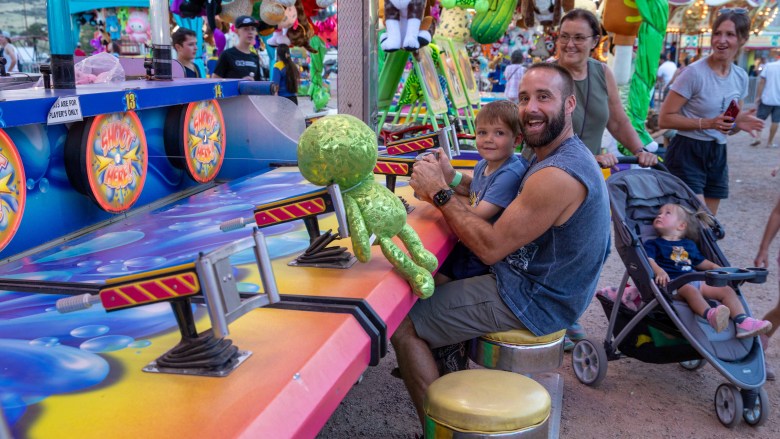 A family plays carnival games.