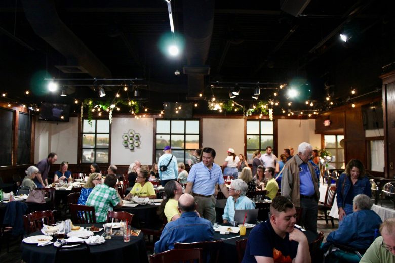 People sit in a restaurant talking to one another.