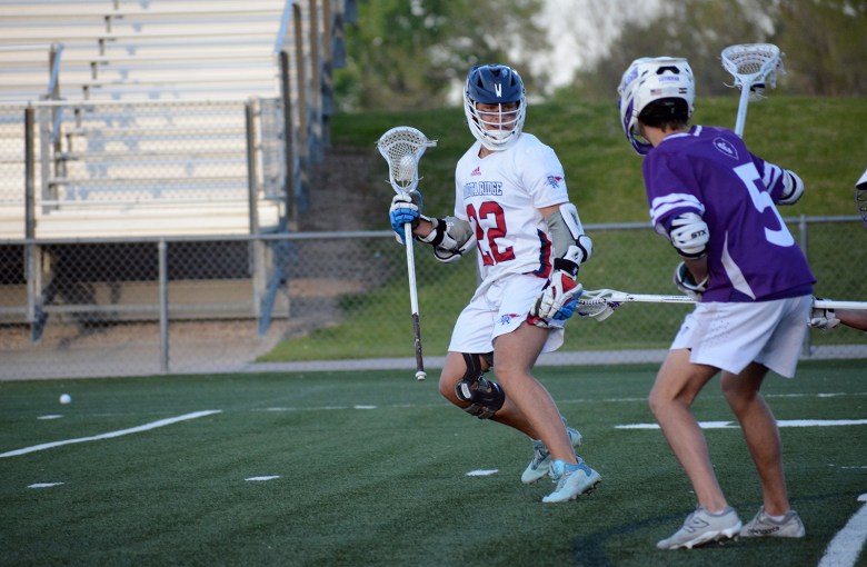 Dakota Ridge junior Brody Spallone (22) holds the ball during the first quarter on Friday, May 9, at Trailblazer Stadium. The Eagles defeated Lutheran 19-5 to advance to the Class 4A quarterfinals.