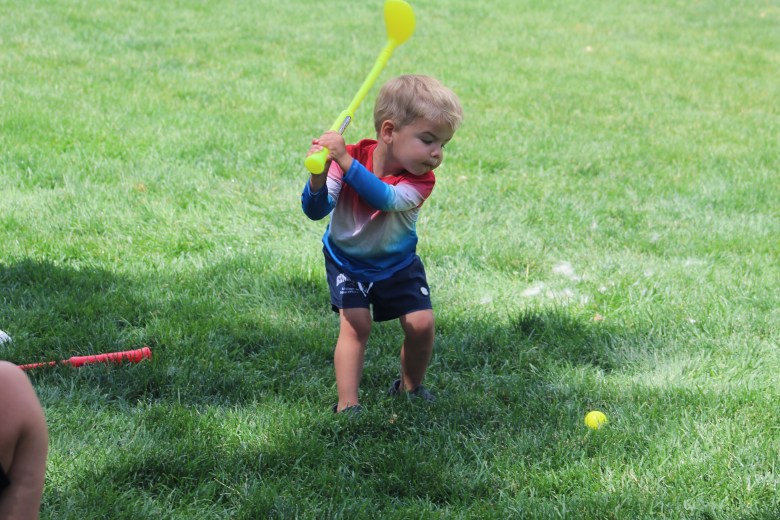Luca, 2, plays with his toy golf set during Golden's 4th of July Festival at Lions Park.
