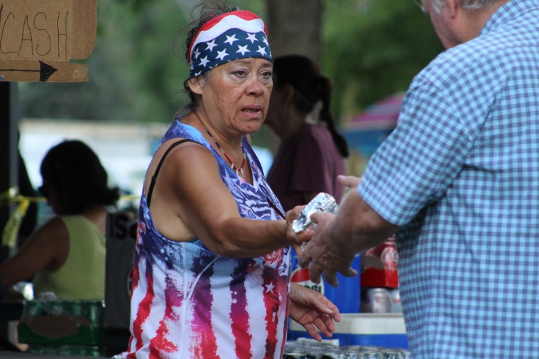 Michelle Nicholson, a volunteer with American Legion Post 21, sells food for the organization's fundraiser at Golden's 4th of July Festival.