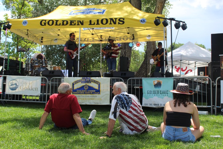 As Jeff Goodwin and the Front Range Cowboys warm up, Goodwin's family members watch from front-row seats during Golden's 4th of July Festival at Lions Park.
