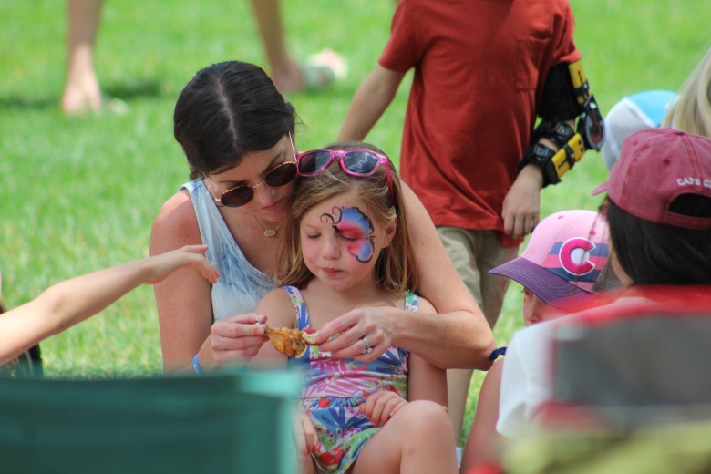 Kimberly Bruno and her 4-year-old Maeve share food during Golden's 4th of July Festival at Lions Park.
