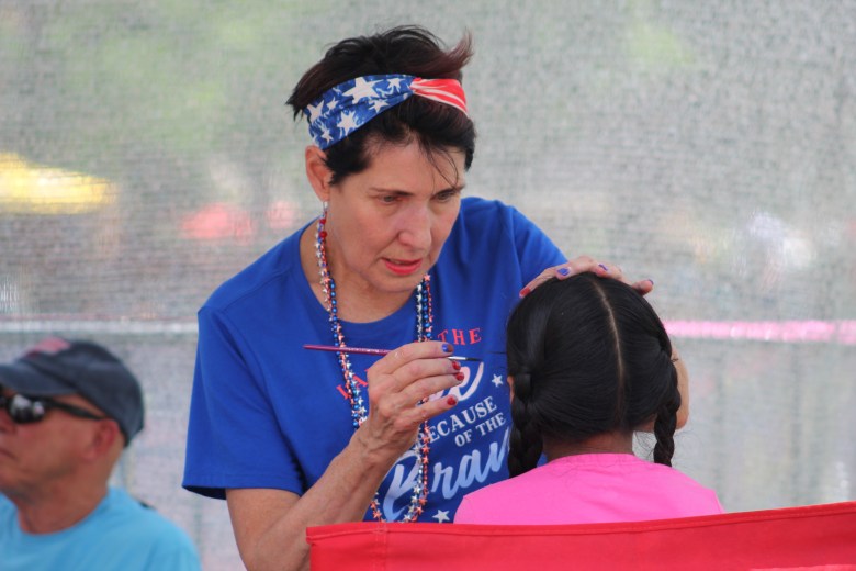 A face-painting artist works during Golden's 4th of July Festival at Lions Park.