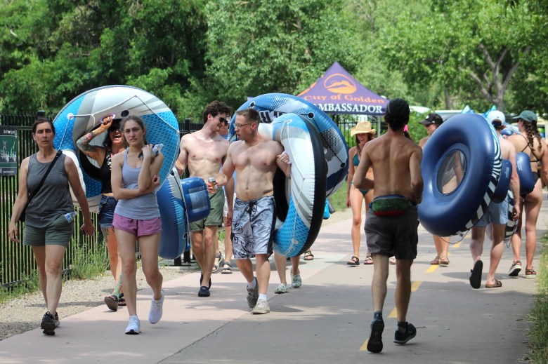 On June 28, groups of tubers and other trail users pass the City of Golden ambassadors' station along the north Clear Creek Trail near the RV park.