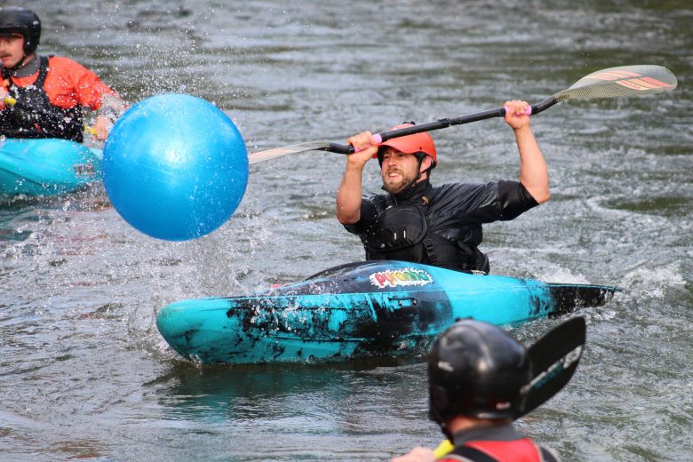 On July 10 at the Clear Creek Whitewater Park, a member of Team H2O hits the yoga ball toward the finish line during the Colorado Whitewater Association's downriver race