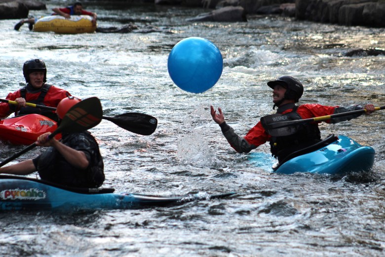 Members of Team H2O hit their yoga ball toward the finish line during the July 10 downriver race at the Clear Creek Whitewater Park.