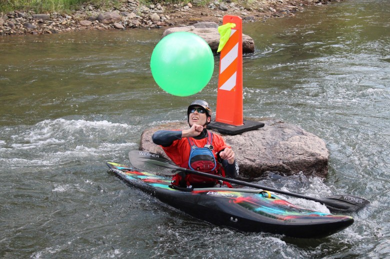 A member of Team Tech Ballers prepares to hit the ball during the July 10 downriver race at the Clear Creek Whitewater Park.