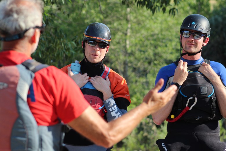 Members of Team Tech Ballers listen to instructions during the pre-race meeting July 10 at the Clear Creek Whitewater Park.