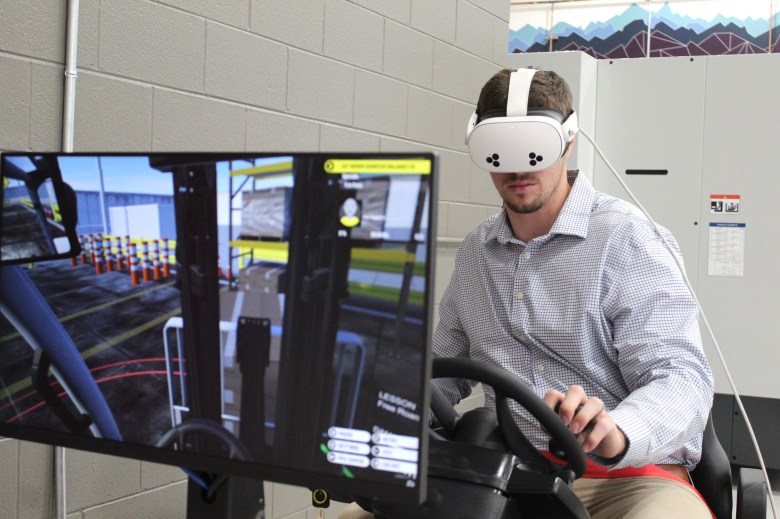 An individual demonstrates the forklift simulator at the new CoorsTek Academy Training Center during the July 16 ribbon-cutting ceremony