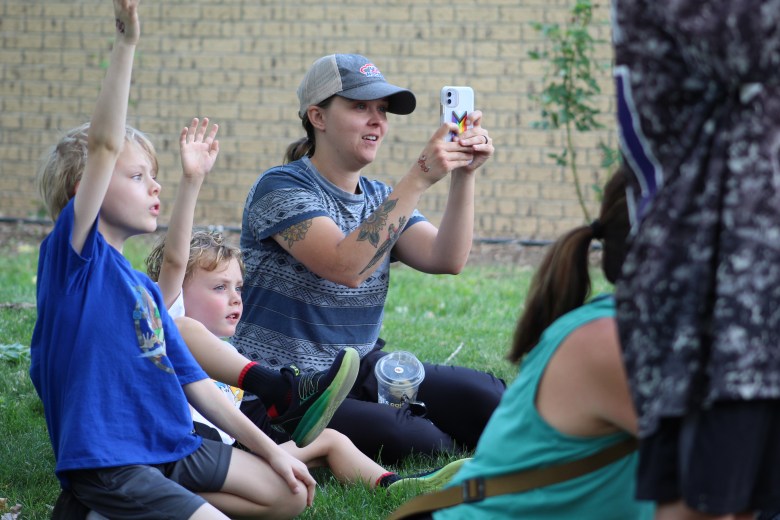 A family reacts to the reveal of Gaia the golden eagle at the July 15 Nature's Educators Talon Talk at the Golden Library