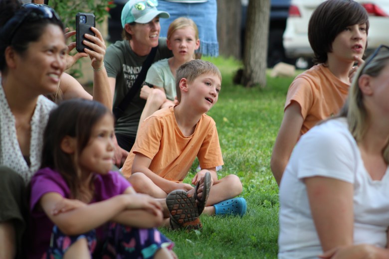 Children and their parents react to the reveal of Gaia the golden eagle at the July 15 Nature's Educators Talon Talk at the Golden Library.