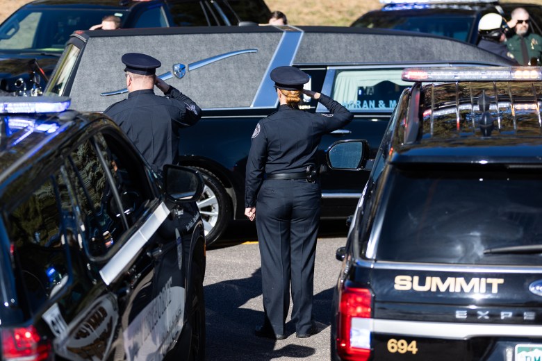 First responders stand and salute as Golden Police Officer Evan Dunn's body is driven to Mission Hills Church on Nov. 13.