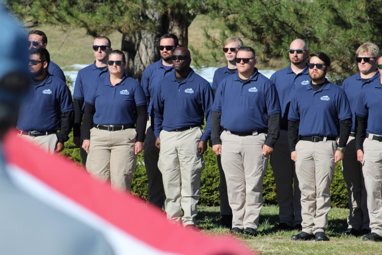 Members of the Red Rocks Community College Police Academy stand at attention as Golden Police Officer Evan Dunn's Nov. 13 funeral procession makes its way down County Line Road to Mission Hills Church.