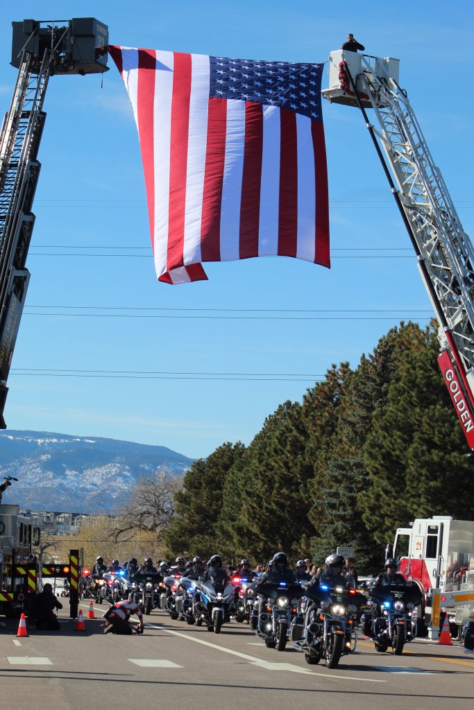 Motorcycle officers lead Golden Police Officer Evan Dunn's funeral procession down County Line Road to Mission Hills Church on Nov. 13.