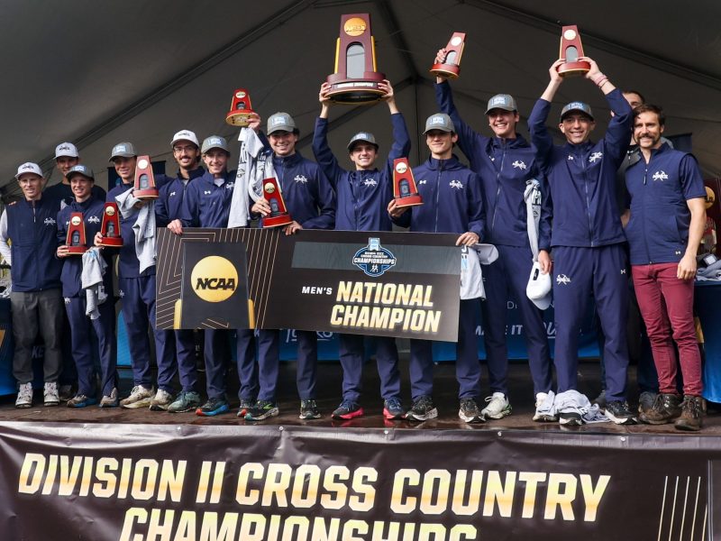 The Colorado School of Mines men's cross country team celebrates winning the 2024 NCAA Division II national title