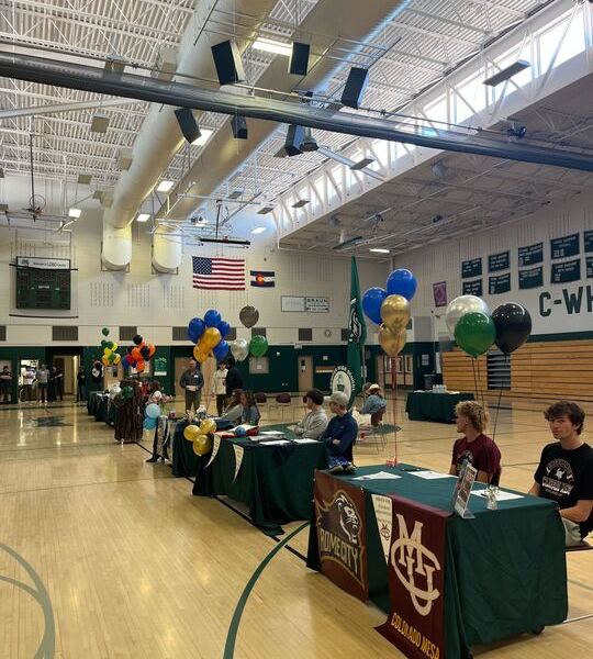 A dozen Conifer High School student athletes put pen to paper to play college sports at the school's Signing Day on April 24.