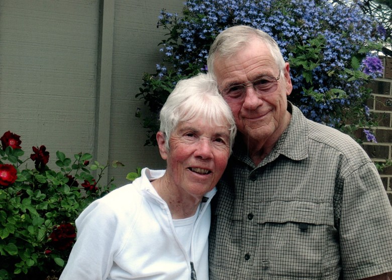 a man and a woman smile at the camera