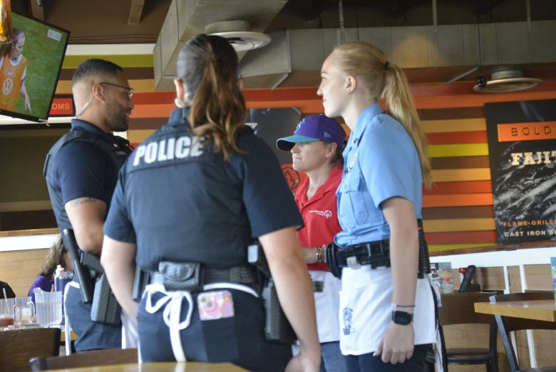 Deputies with the Parker Police Department stand with a special olympic athlete.