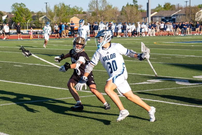Valor Christian's Eliot Fuhs (30) tries to run past Rock Canyon's Tripp Mulstay (8) in a Class 5A second-round boys lacrosse game on May 10 at Valor Stadium. Valor won 16-2.