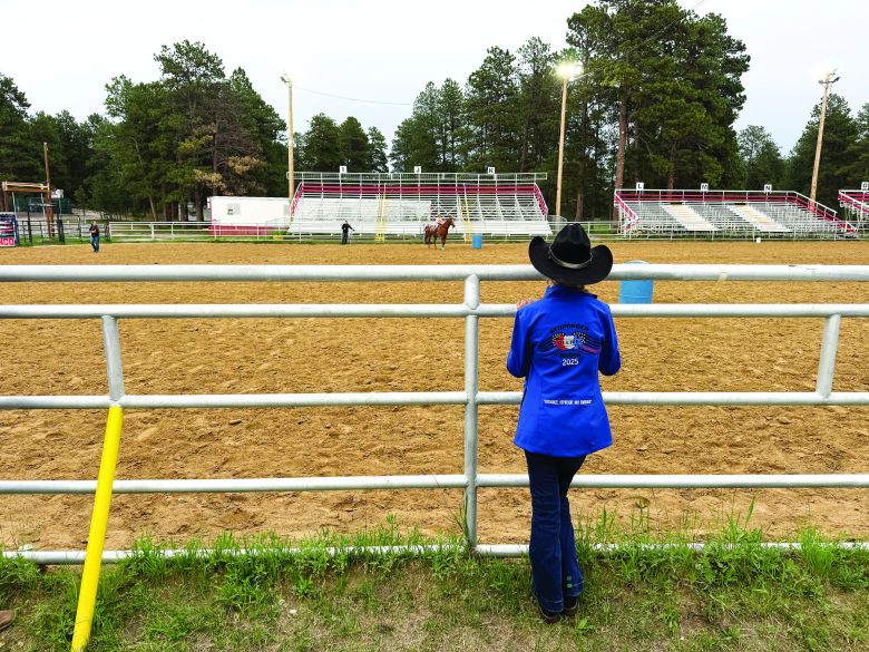 At the Responder Relief Rodeo Gymkhana on June 24, Princess McKinley Holden watches a young contestant compete in the barrel race.