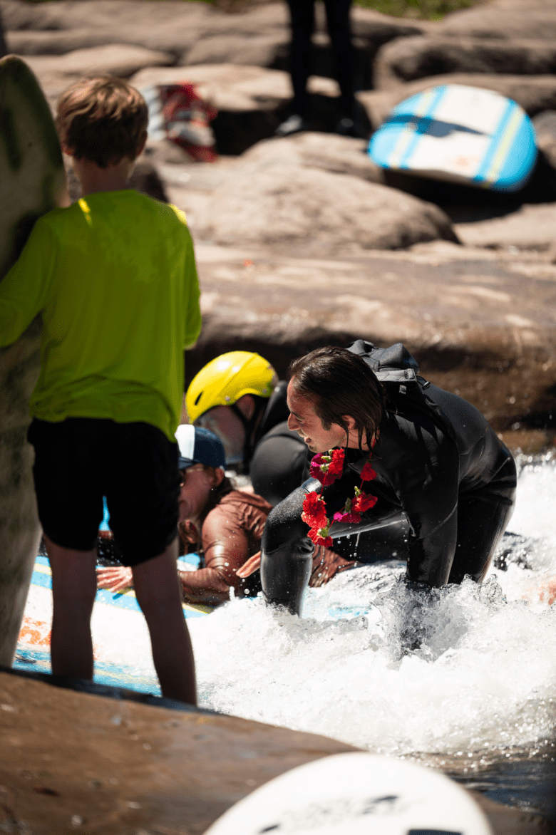 Local surfers ride the party wave for Nathan Ginn at a paddle-out ceremony at River Run Park on May 3.