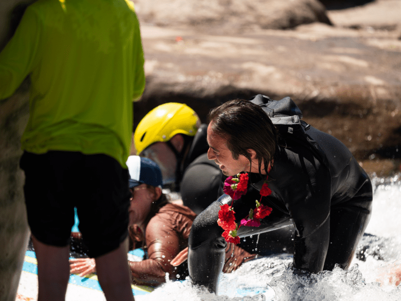 Local surfers ride the party wave for Nathan Ginn at a paddle-out ceremony at River Run Park on May 3.